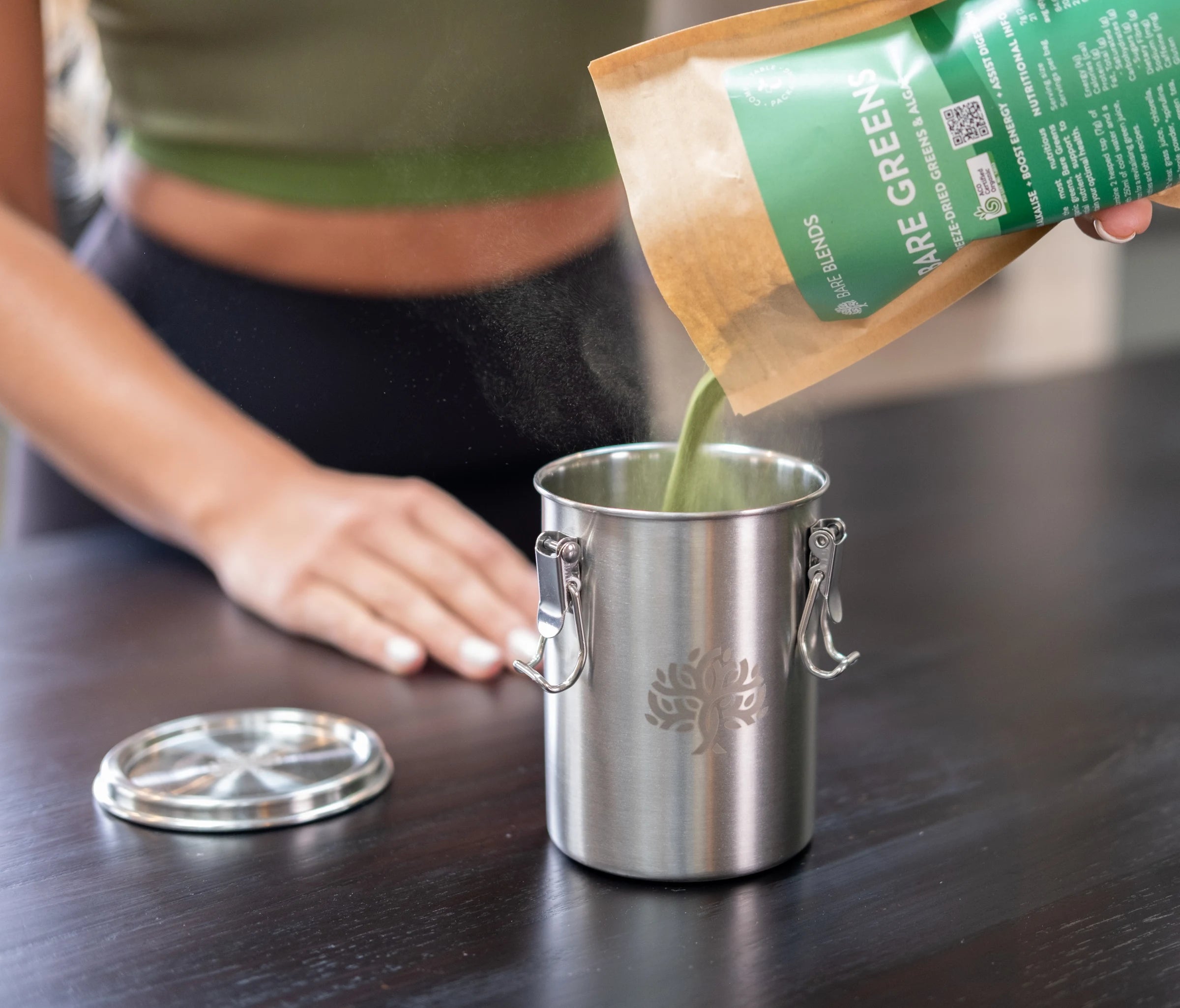 Bare Greens being poured into a stainless steel Bare Blends canister