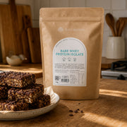 Bare Whey Protein Isolate 750g pouch beside homemade chocolate protein bars in a kitchen