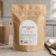 Bare Blends Raw Cacao WPI 750g pouch beside a chocolate protein shake