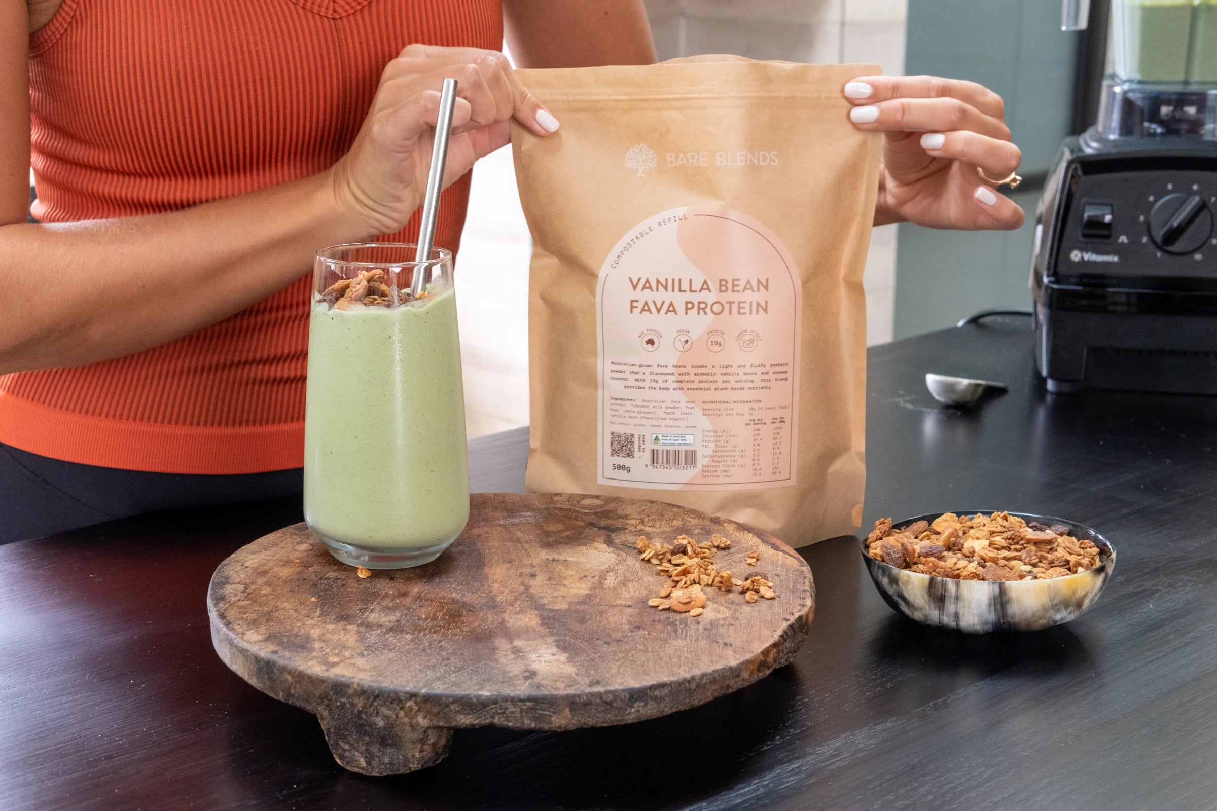 Bare Blends Vanilla Bean Fava Protein beside a green smoothie